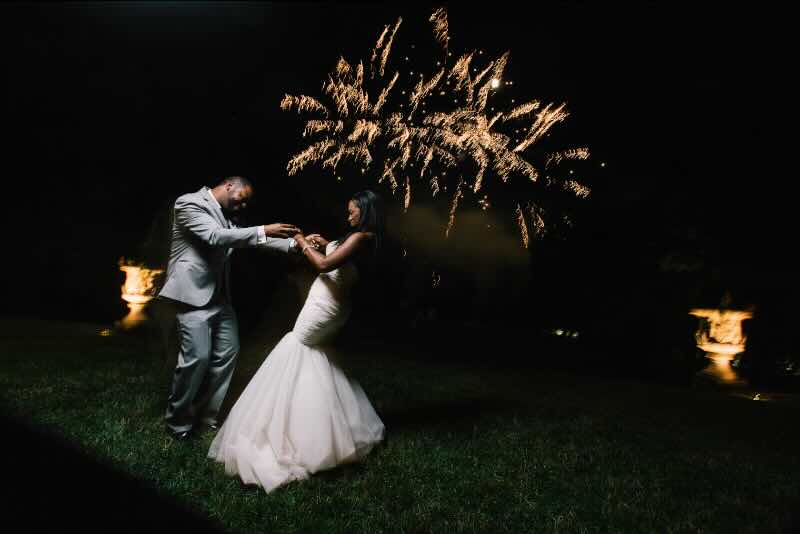 Wedding couple dancing to fireworks